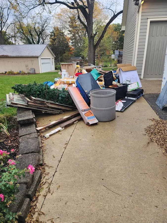 Dumpster being loaded with debris for 10 Yard Dumpster Rental in Goshen